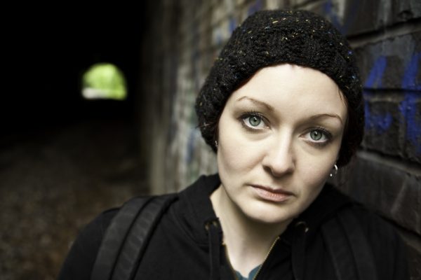 Woman with Backpack Next to Tunnel Woman with Backpack Next to Tunnel.See more from this series: